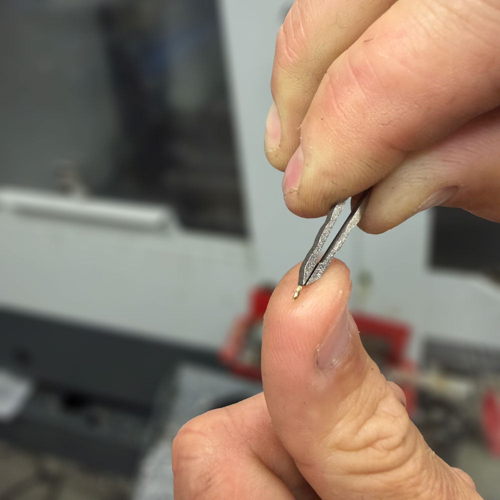 Titanium-Tweezers-in-KeyBar-Key-and-Tool-Holdler-Removing-Metal-Chip-from-Fingertip