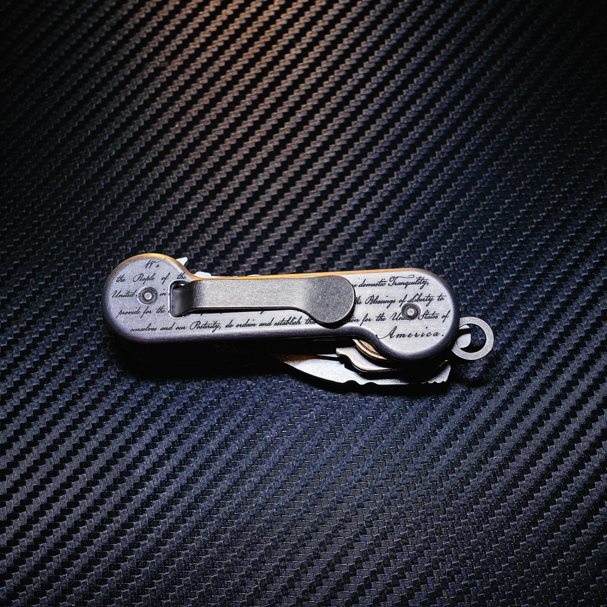 Aluminum Freedom KeyBar Key and Tool Holder closed back with standard titanium pocket clip, key fob and bottle opener.