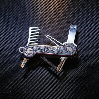 Aluminum Engraverhand KeyBar Key and Tool Holder with titanium beard comb and tweezers, flashdriver, and 3D printed body with pen insert.