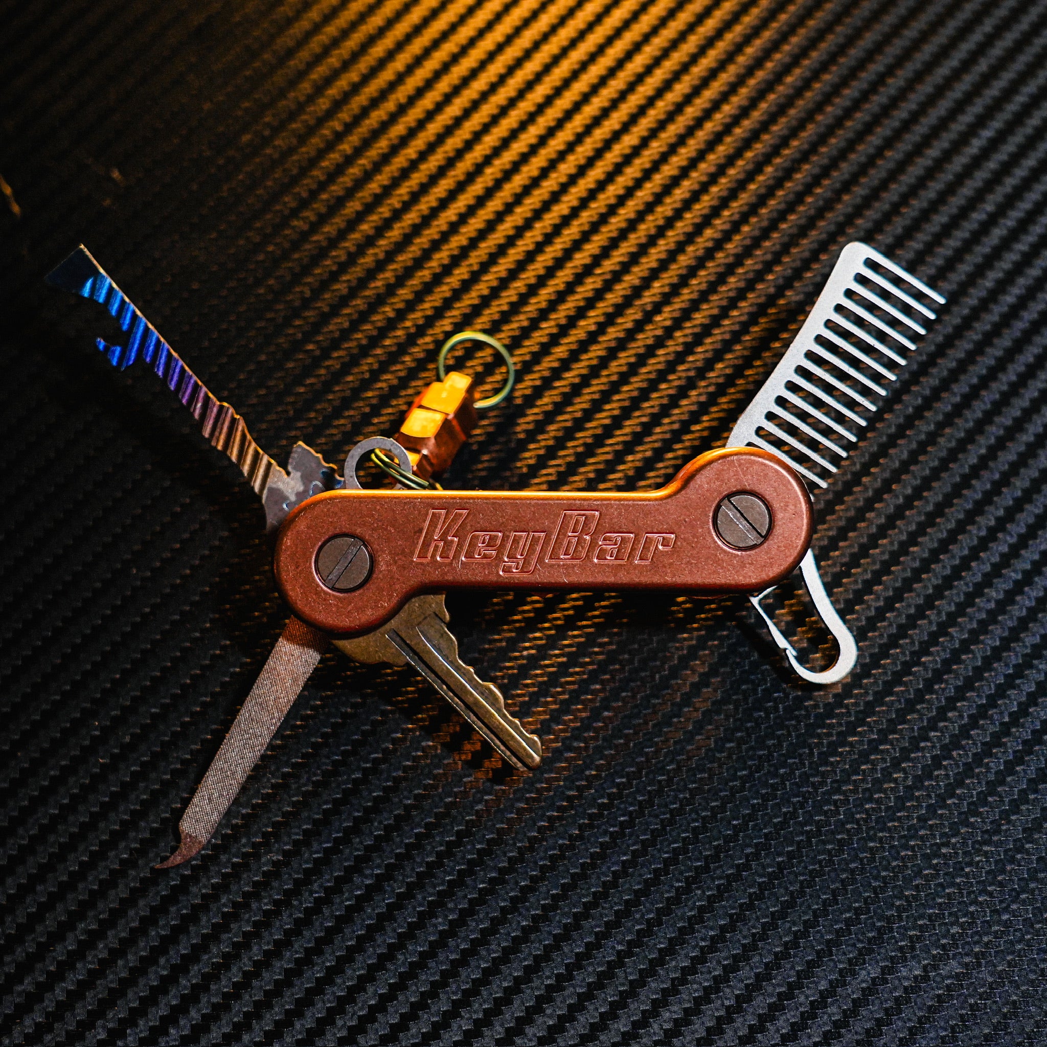 Copper KeyBar Key and Tool Holder open front with titanium beard comb, keyrabiner 4.0, skeleton key, and nail file, and copper magnuts. 