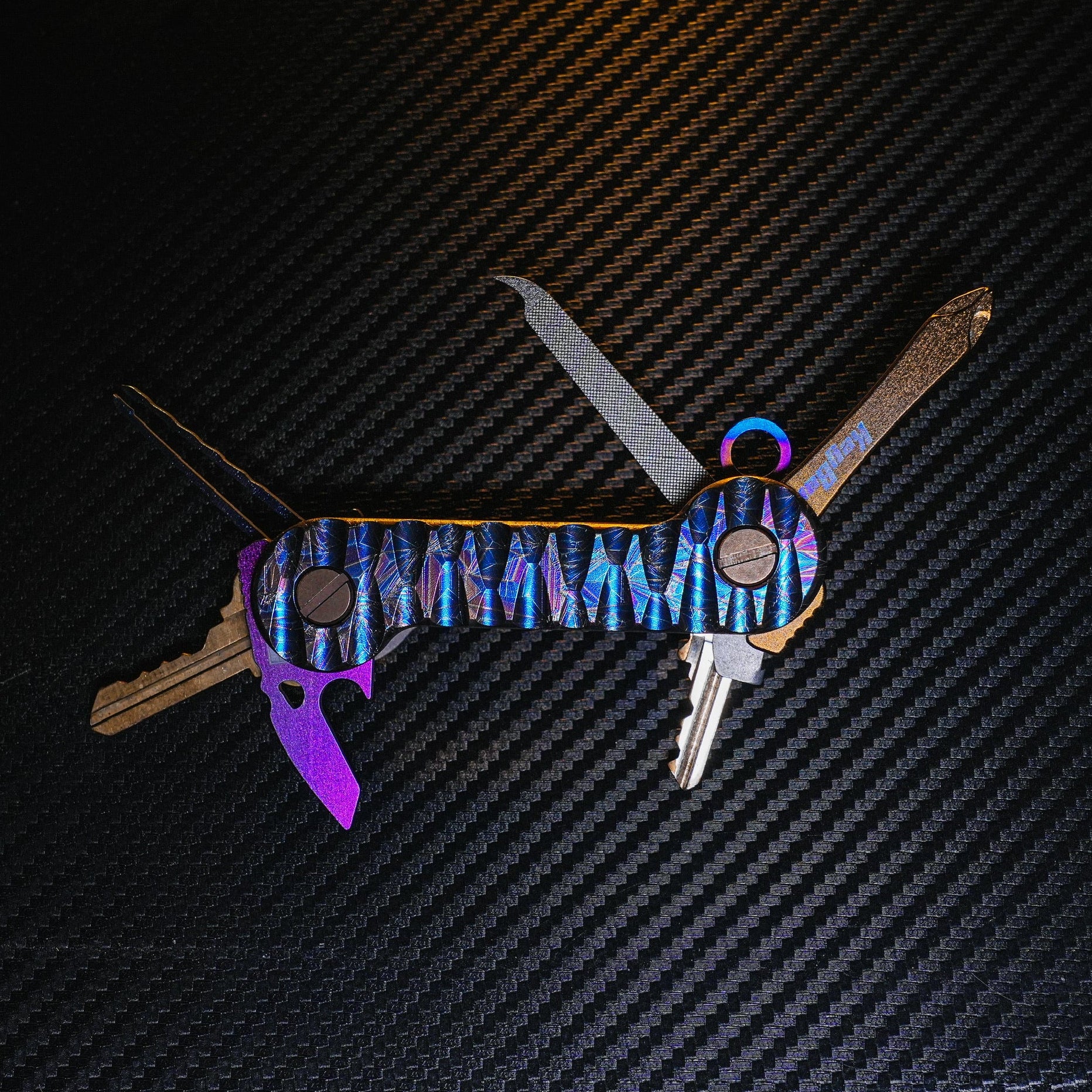 Crystallized Slayer Titanium KeyBar Key and Tool Organizer with titanium nail file, titanium phillips head screwdriver, titanium bottle opener, titanium tweezers and aluminum quick key tab - open.