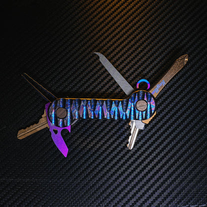 Crystallized Slayer Titanium KeyBar Key and Tool Organizer with titanium nail file, titanium phillips head screwdriver, titanium bottle opener, titanium tweezers and aluminum quick key tab - open.