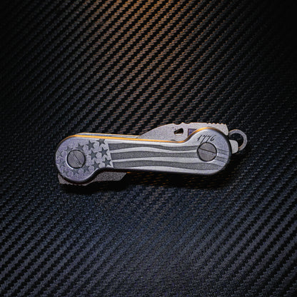 Freedom Aluminum Laser-Engraved KeyBar Key and Tool Organizer closed front with titanium bottle bomber and mini uility tool.