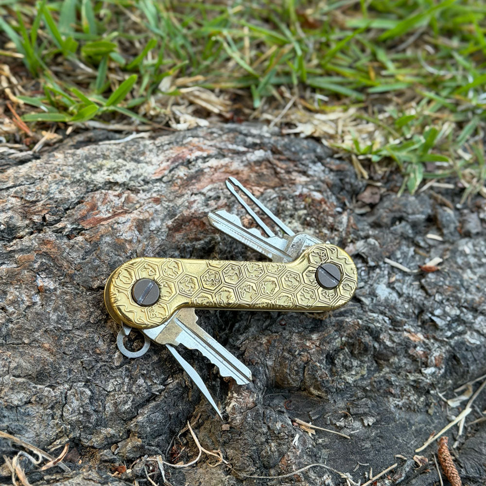 Honeycomb-Brass-KeyBar-Key-and-Tool-Organizer-lifestyle-image-on-tree-root