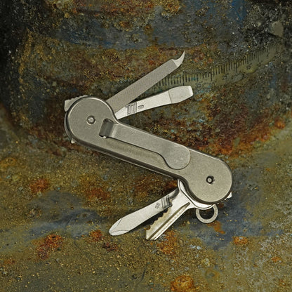 Titanium-KeyBar-Key-and-Tool-Organizer-Back-Open-with-Titanium-File_-Flathead-Screwdriver-and-Phillips-Screwdriver-On-Chips