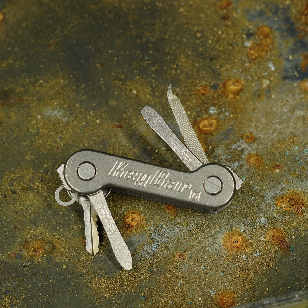Titanium-KeyBar-Key-and-Tool-Organizer-Front-Open-with-Titanium-File_-Flathead-Screwdriver-and-Phillips-Screwdriver-On-Chips