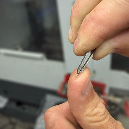 Titanium-Tweezers-in-KeyBar-Key-and-Tool-Holdler-Removing-Metal-Chip-from-Fingertip