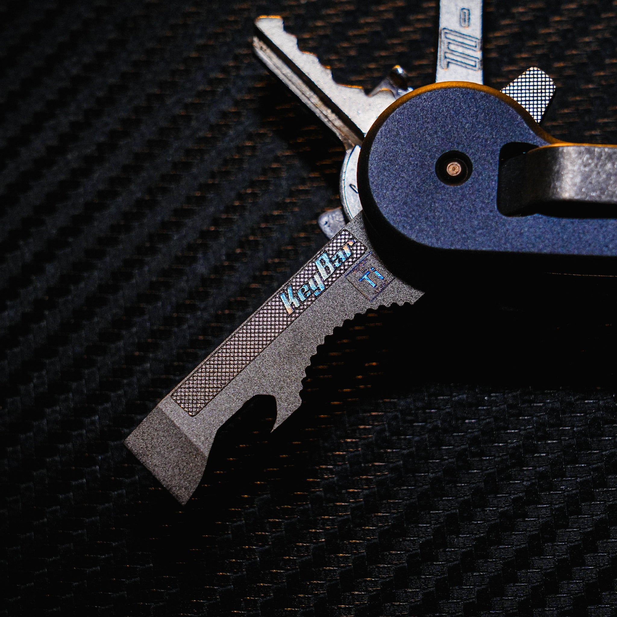 Titanium Multi-Tool Insert for KeyBar extending from KeyBar.